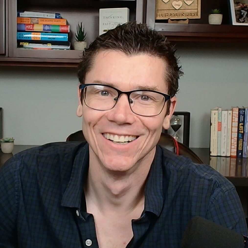 Digital marketing expert TJ Robertson smiling in a home office studio with bookshelves, guest on Counsel Cast.