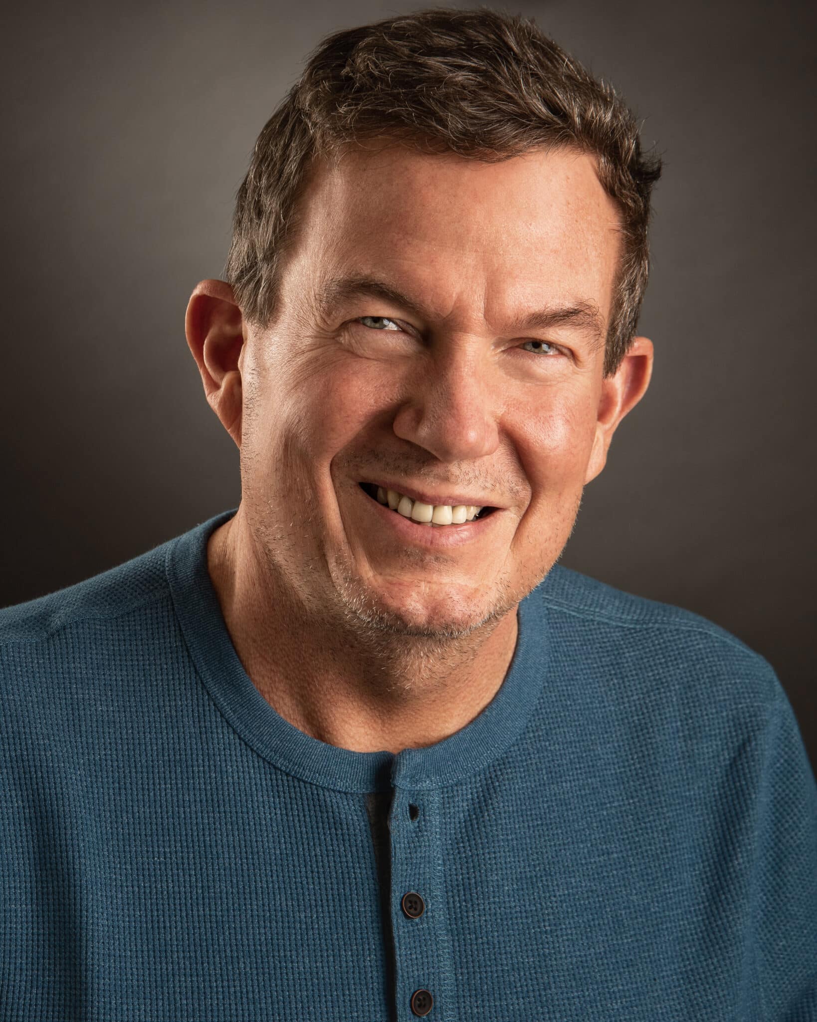 Professional studio headshot of Terry L. Fossum smiling in a blue shirt, guest on Counsel Cast.