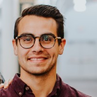 Professional headshot of Nate Ruiz, Director of Product Management at NetDocuments, wearing glasses and a burgundy shirt.