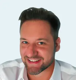 Professional headshot of Joey Organisciak, CEO of Case Compass, smiling in a white shirt.